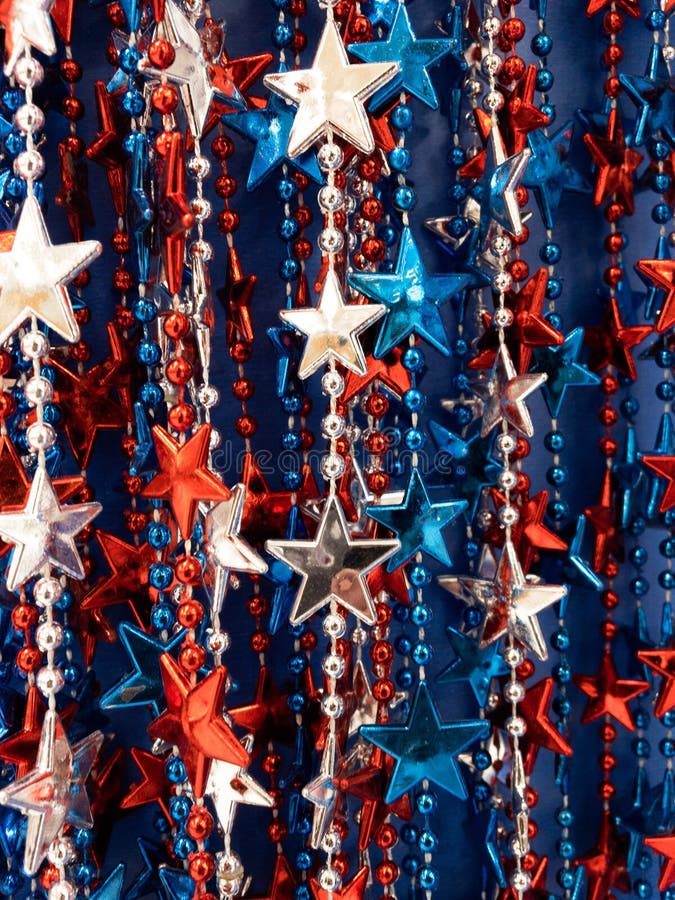 Strands of red,white & blue beads,stars, great background for July 4th. Memorial Day, Patriots Day,Remembrance Day,patriotic backgrounds.Vertically aligned royalty free stock image