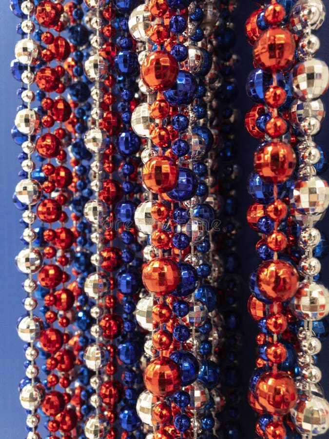 Strands of red,white & blue beads,stars, great background for July 4th. Memorial Day, Patriots Day,Remembrance Day,patriotic backgrounds.Vertically aligned stock photo