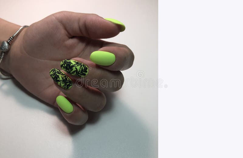 Stylish design of green manicure on beautiful nails royalty free stock photo