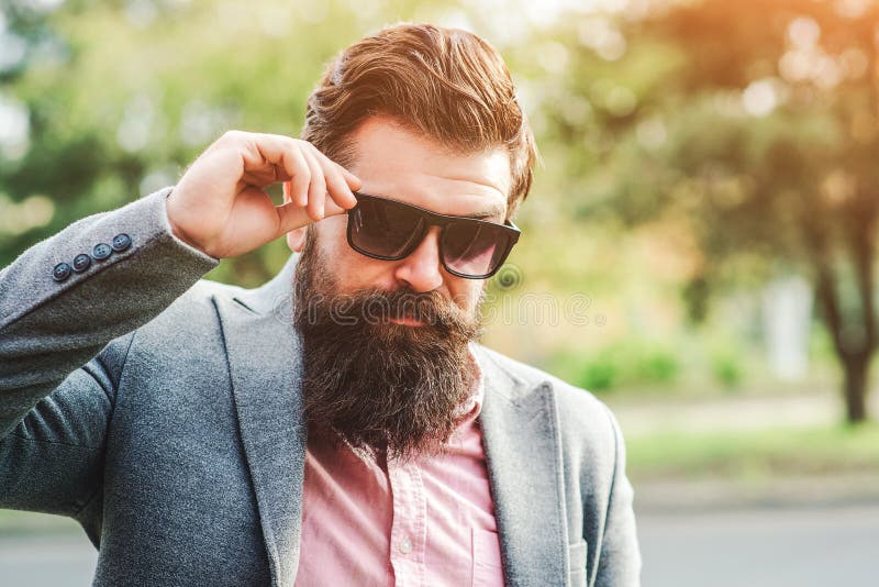 Successful bearded man in suit outdoors. Male fashion. Fashionable hairstyle and beard. Brutal confident man. Handsome bearded businessman in classic suit and royalty free stock images