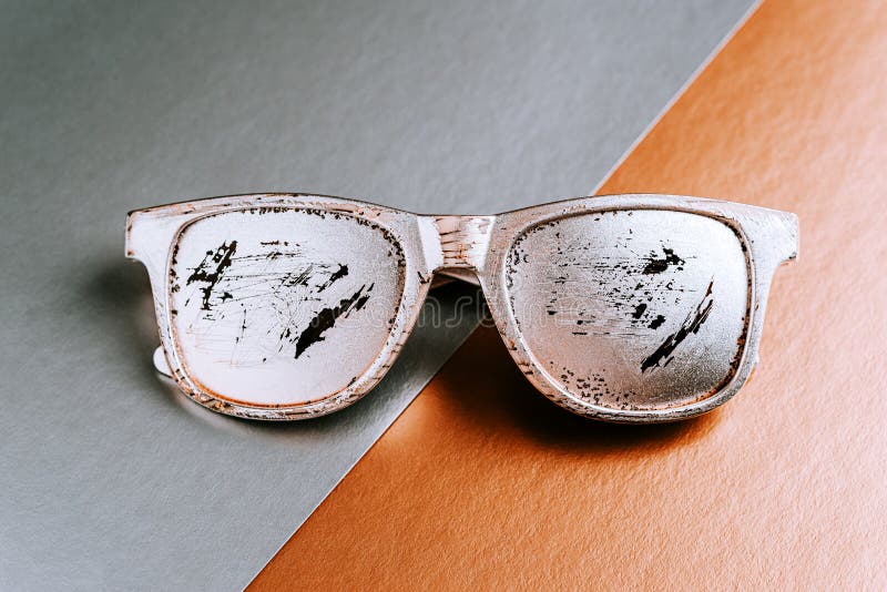 Summer glasses silver color with scratches on a gray copper paper geometric background.  royalty free stock image