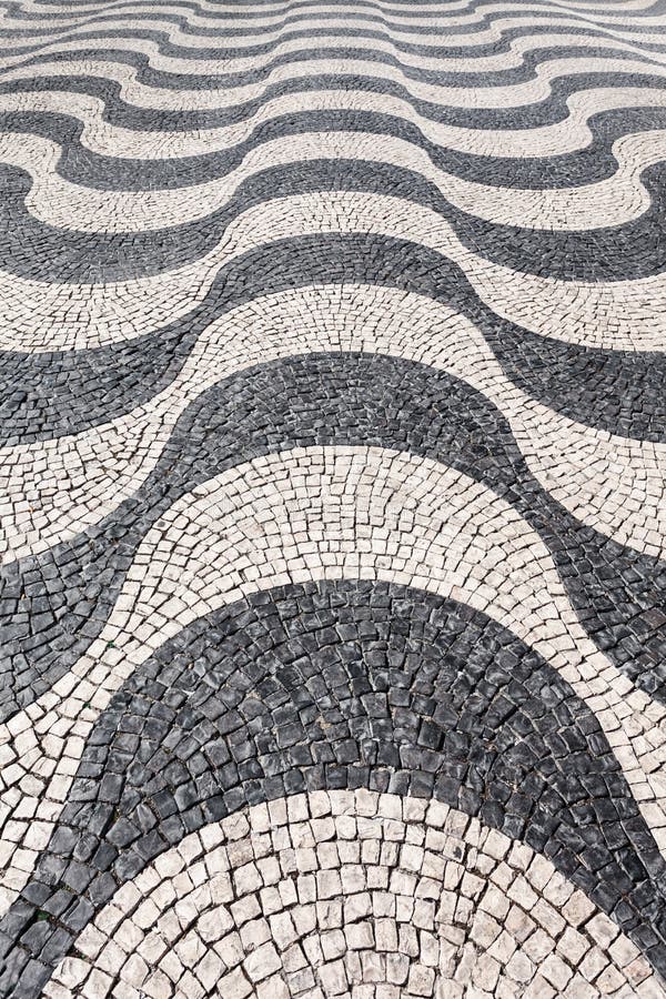 Waves of tiled floor. In portuguese traditional style, Rossio square, Lisbon royalty free stock images