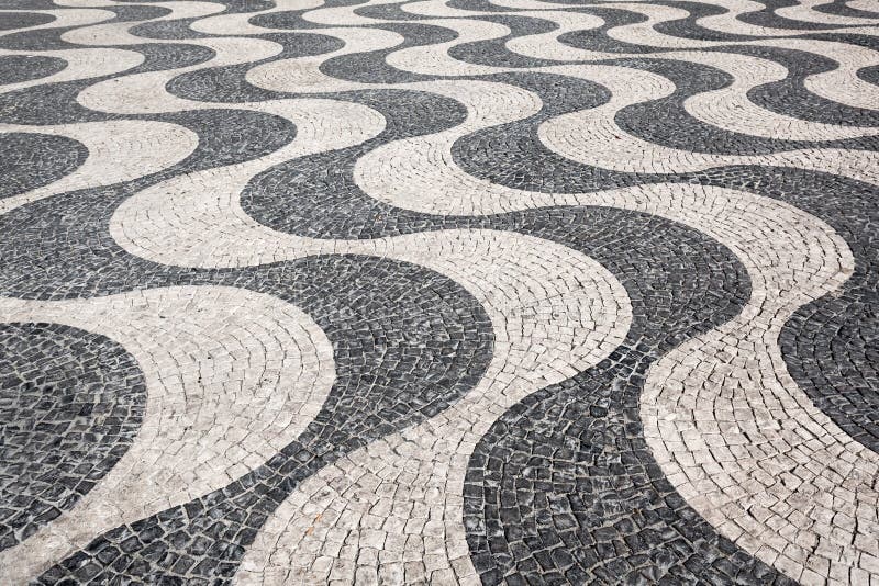 Waves of tiled floor. In portuguese traditional style, Rossio square, Lisbon royalty free stock photography