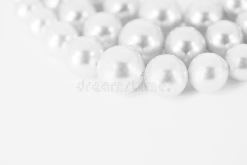 White Pearls. High key image of white strands of pearls with copy space royalty free stock image