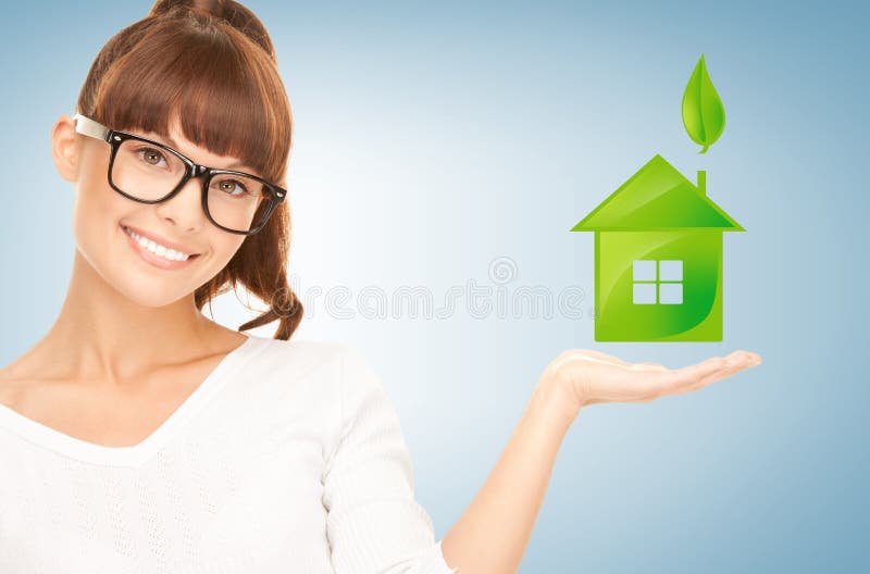 Woman holding green house in her hands royalty free stock images