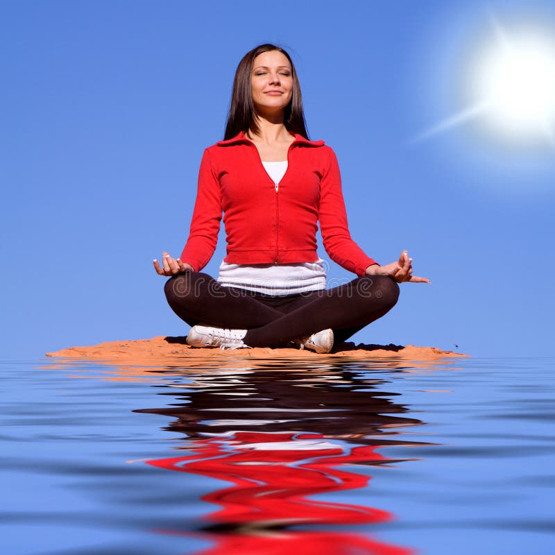 Woman meditating on rocks. Young woman meditating on red rocks stock images