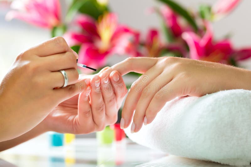 Woman in nail salon receiving manicure royalty free stock photo