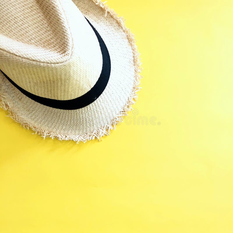 Woven hat on pastel yellow color background summer square. Decoration fashion stock images