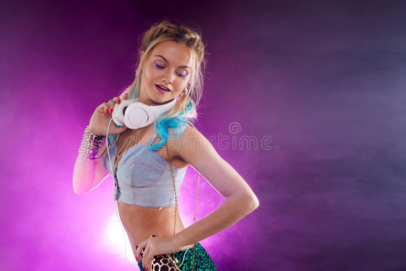 Young fashionable girl in disco style. Listening music and enjoying. Retro style. Young fashionable girl in disco style. Listening to music and enjoying. Retro royalty free stock photo