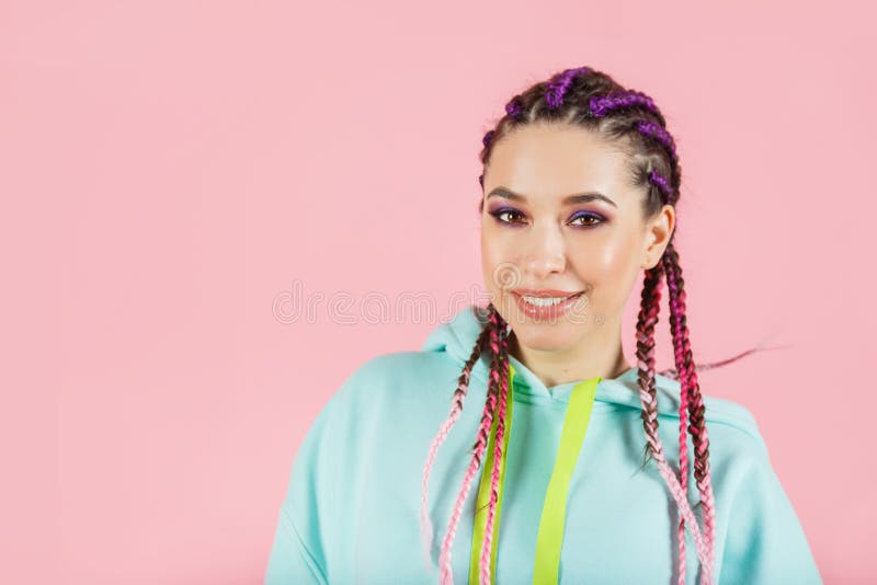 Young smiling fashionable woman with braids kanekalon. Colored artificial strands of hair.  royalty free stock photography