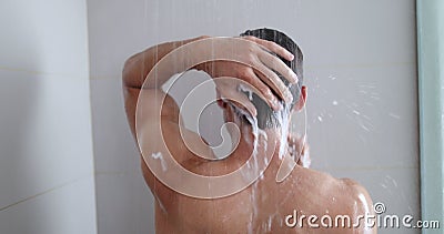Man taking a shower washing hair with shampoo product under water stock footage