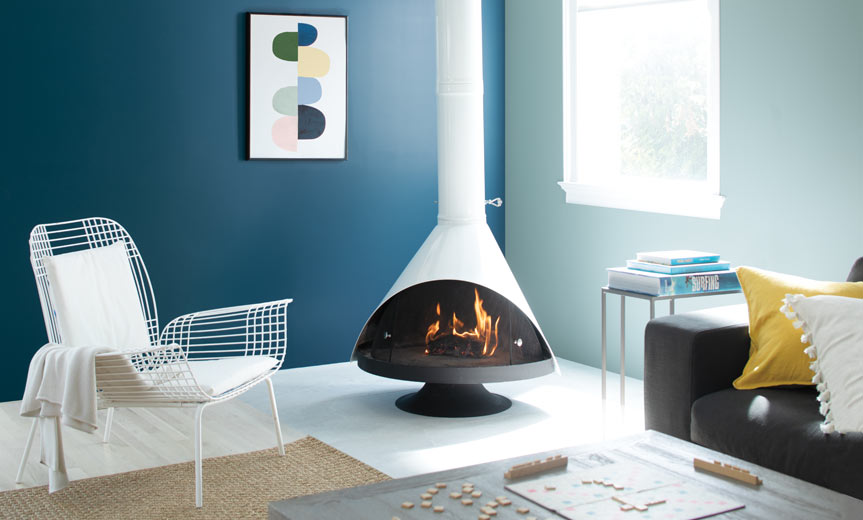 A cozy living room complete with a retro fireplace accompanied by blue painted walls A cozy living room complete with a retro fireplace accompanied by blue painted walls