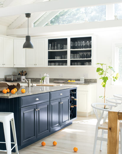 A bright, airy kitchen with blue island and white walls and cabinets A bright, airy kitchen with blue island and white walls and cabinets