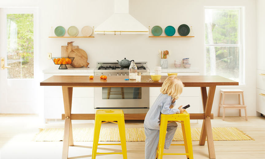 An open, inviting kitchen with neutral walls and bright yellow chairs An open, inviting kitchen with neutral walls and bright yellow chairs