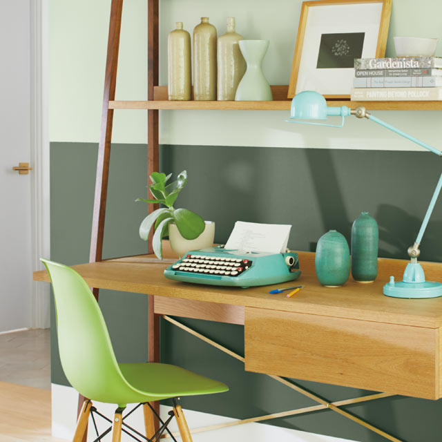 A two-tone green home office wall with green office chair A two-tone green home office wall with green office chair