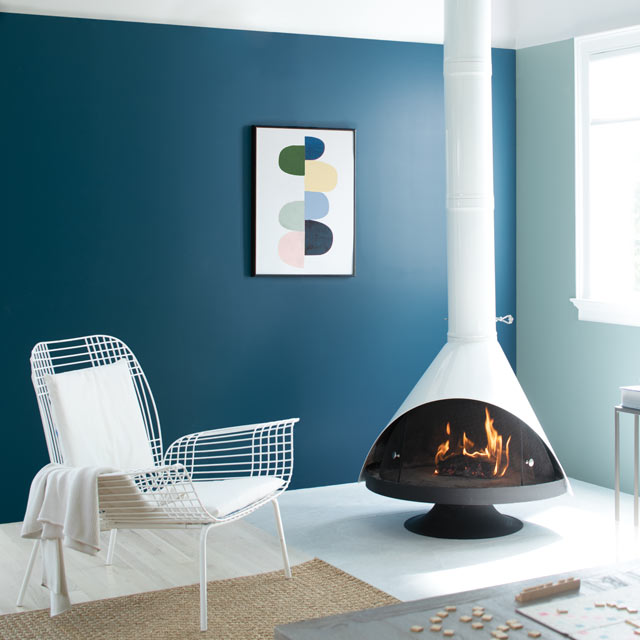 A cozy living room complete with a retro fireplace accompanied by blue painted walls A cozy living room complete with a retro fireplace accompanied by blue painted walls