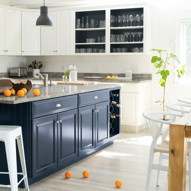 A bright, airy kitchen with blue island and white walls and cabinets A bright, airy kitchen with blue island and white walls and cabinets
