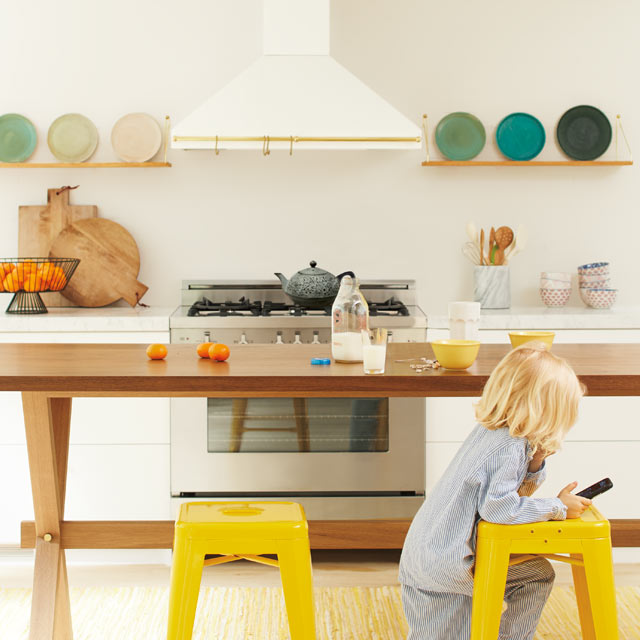 An open, inviting kitchen with neutral walls and bright yellow chairs An open, inviting kitchen with neutral walls and bright yellow chairs