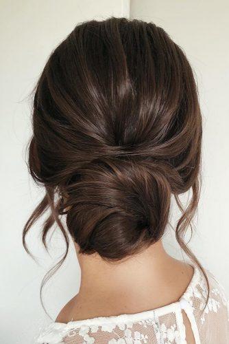 wedding hairstyles for long hair low simple bun on dark hair with loose curls caraclyne.bridal